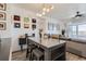 A dining area features a modern light fixture, a wooden table with chairs, and stylish decor at 4100 Albion St # 221, Denver, CO 80216