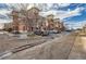 Brick and tan apartment building with parking spaces, parked cars and bare trees at 4100 Albion St # 221, Denver, CO 80216