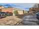 Row of single car garages next to an apartment complex and parking area at 4100 Albion St # 221, Denver, CO 80216