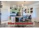 A stylish eat-in kitchen features mint-green cabinets, a subway tile backsplash, and a pendant light over the dining area at 4100 Albion St # 221, Denver, CO 80216