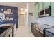 Stylish kitchen with stainless appliances, modern tile backsplash, and ample storage at 4100 Albion St # 221, Denver, CO 80216