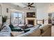Bright living room featuring a modern fireplace, plush sectional sofa, and balcony access at 4100 Albion St # 221, Denver, CO 80216