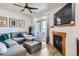 Comfortable living room with modern fireplace, entertainment center, and sliding doors to a private balcony at 4100 Albion St # 221, Denver, CO 80216