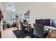 Bright office space offers hardwood floors, dual workstations, and a view into the living room at 4100 Albion St # 221, Denver, CO 80216