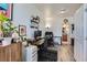 Bright office space offers hardwood floors, dual workstations, and a view into the well-lit bathroom at 4100 Albion St # 221, Denver, CO 80216
