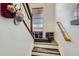Entryway staircase boasting a metal railing, a window for natural light, and shoe storage at 4100 Albion St # 221, Denver, CO 80216