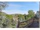 Scenic view from the wooden deck, featuring trees, hills, and a clear blue sky at 165 Washington St, Golden, CO 80403