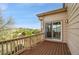 A wooden balcony overlooking trees and mountains and leading into the home through sliding glass doors at 165 Washington St, Golden, CO 80403