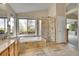 Spacious bathroom featuring a soaking tub, glass enclosed shower, and double vanity with generous natural light at 165 Washington St, Golden, CO 80403