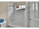 Full white tiled bathtub and shower combination with mountain view at 165 Washington St, Golden, CO 80403