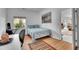 Cozy bedroom features natural light, hard wood floors, and modern decor at 165 Washington St, Golden, CO 80403