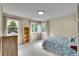 A bright bedroom with neutral walls and carpet features 2 large windows at 165 Washington St, Golden, CO 80403