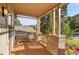 Inviting covered porch features wood flooring, brick pillars, and views of the surrounding nature at 165 Washington St, Golden, CO 80403