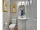 Cozy powder room with a white vanity, oval mirror, and framed artwork at 165 Washington St, Golden, CO 80403