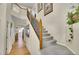 Carpeted staircase with wood and wrought iron railing leads to the upper level of the home at 165 Washington St, Golden, CO 80403