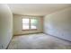 Spacious carpeted bedroom with two windows, offering great natural light and room to personalize at 11884 Elk Head Range Rd, Littleton, CO 80127