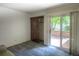 Serene bedroom featuring a sliding glass door to the patio and closet space, offering a seamless indoor-outdoor living experience at 11884 Elk Head Range Rd, Littleton, CO 80127