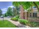Charming brick exterior of the townhouse with landscaped front yard and sidewalk at 11884 Elk Head Range Rd, Littleton, CO 80127