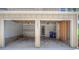 Two-car garage with concrete floors, shelving, and access door to the exterior at 11884 Elk Head Range Rd, Littleton, CO 80127