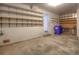 Spacious garage with concrete floors, shelving, and access door to the exterior at 11884 Elk Head Range Rd, Littleton, CO 80127