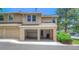 Townhouse exterior featuring open garages and well-kept surroundings at 11884 Elk Head Range Rd, Littleton, CO 80127