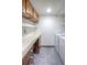 Functional laundry area with ample counter space and overhead cabinets at 11884 Elk Head Range Rd, Littleton, CO 80127