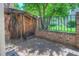 Private patio with brick walls and wooden gate offers a secluded outdoor space for relaxation and entertainment at 11884 Elk Head Range Rd, Littleton, CO 80127