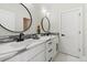 Well-lit bathroom with dual sinks, modern fixtures, and a sleek design at 27250 E Nova Cir, Aurora, CO 80016