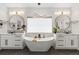 Elegant bathroom with a freestanding tub, dual vanities, and stylish lighting at 27250 E Nova Cir, Aurora, CO 80016