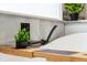 Close up of a modern soaking tub with black fixtures and a bamboo bath tray at 27250 E Nova Cir, Aurora, CO 80016