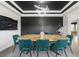 Dining room with modern light fixture, wood table, teal chairs, and decorative wall paneling at 27250 E Nova Cir, Aurora, CO 80016