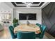 Dining room featuring a modern light fixture, unique wood table, and stylish teal chairs at 27250 E Nova Cir, Aurora, CO 80016