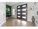 Entryway featuring double doors with glass panes, hardwood flooring, and modern decor at 27250 E Nova Cir, Aurora, CO 80016