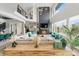 Open-concept living room with fireplace, high ceilings, comfortable seating, and natural light at 27250 E Nova Cir, Aurora, CO 80016