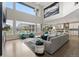 Bright, open-concept living room with large windows, high ceilings, and comfortable seating area at 27250 E Nova Cir, Aurora, CO 80016