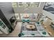 High-angle view of living room with large windows, fireplace, and comfortable seating area at 27250 E Nova Cir, Aurora, CO 80016