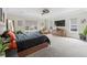 Bright main bedroom featuring a ceiling fan, dresser, and multiple windows at 27250 E Nova Cir, Aurora, CO 80016