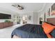 Bright main bedroom featuring a ceiling fan, dresser, and ensuite bathroom access at 27250 E Nova Cir, Aurora, CO 80016