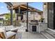 Outdoor kitchen equipped with a grill, counter space, and seating area for entertainment at 27250 E Nova Cir, Aurora, CO 80016