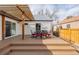 Stunning backyard deck with pergola and outdoor dining set, perfect for entertaining at 1190 Glencoe St, Denver, CO 80220