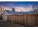 View of back yard with a wooden privacy fence and detached garage at 1190 Glencoe St, Denver, CO 80220