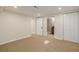 Open basement area with views into a bathroom through a white paneled door at 1190 Glencoe St, Denver, CO 80220