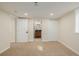 Spacious basement area with access to a bathroom and closets through white paneled doors at 1190 Glencoe St, Denver, CO 80220