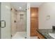 Bathroom featuring a glass shower with a dual shower head and a built-in niche at 1190 Glencoe St, Denver, CO 80220