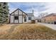 A charming home featuring Tudor-style accents, a well-manicured lawn, and mature landscaping at 1190 Glencoe St, Denver, CO 80220
