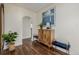 Inviting hallway with hardwood floors, stylish decor, and an arched doorway at 1190 Glencoe St, Denver, CO 80220