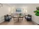 Inviting living room with a gray sofa, armchairs, a coffee table, lamps, and decorative artwork at 1190 Glencoe St, Denver, CO 80220