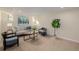 Bright living room includes a gray sofa, armchairs, a coffee table, and large potted plant at 1190 Glencoe St, Denver, CO 80220