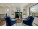 Elegant living room featuring a cozy fireplace, plush seating, and natural light at 1190 Glencoe St, Denver, CO 80220