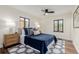 Cozy bedroom with a ceiling fan, stylish rug, and two windows at 1190 Glencoe St, Denver, CO 80220